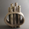 Large ceramic sculpture in pale gray with multiple tubular spouts
