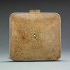 Small square camel colored shagreen bag with wrist strap.